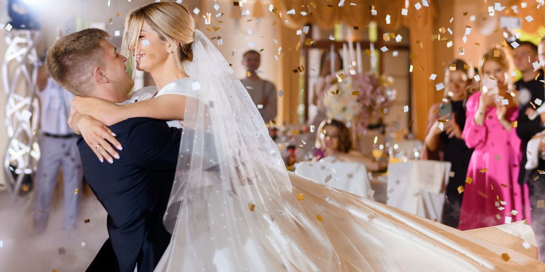 Bride Couple Waving While Dacning With Confetti