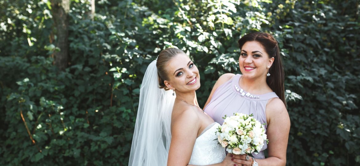 bride-with-bridesmaid-posing-garden