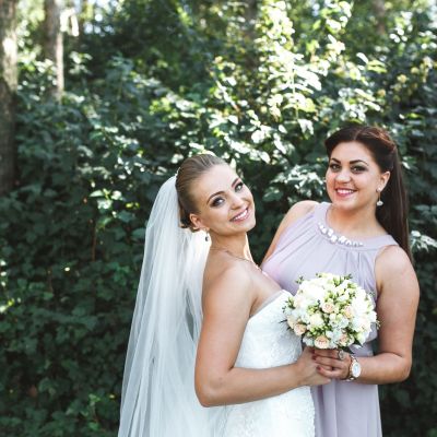 bride-with-bridesmaid-posing-garden